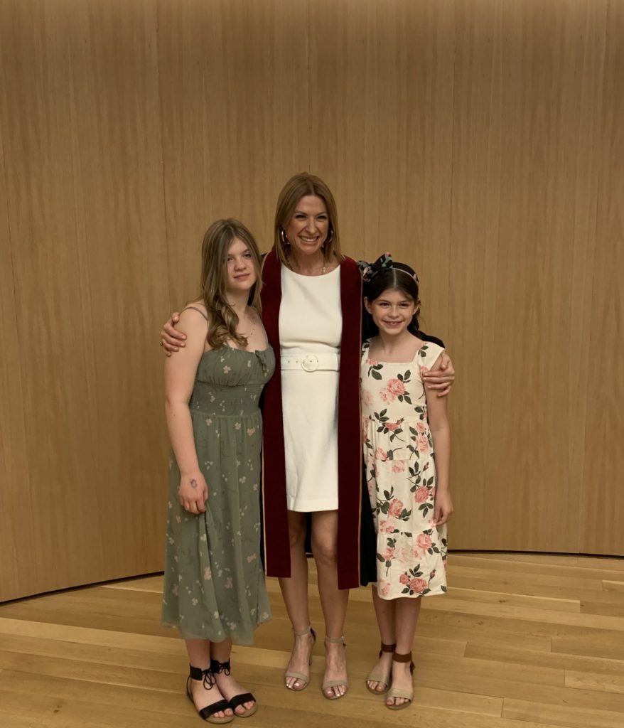 Actua's CEO, Jennifer Flanagan, stands with her two young daughters at Concordia University
