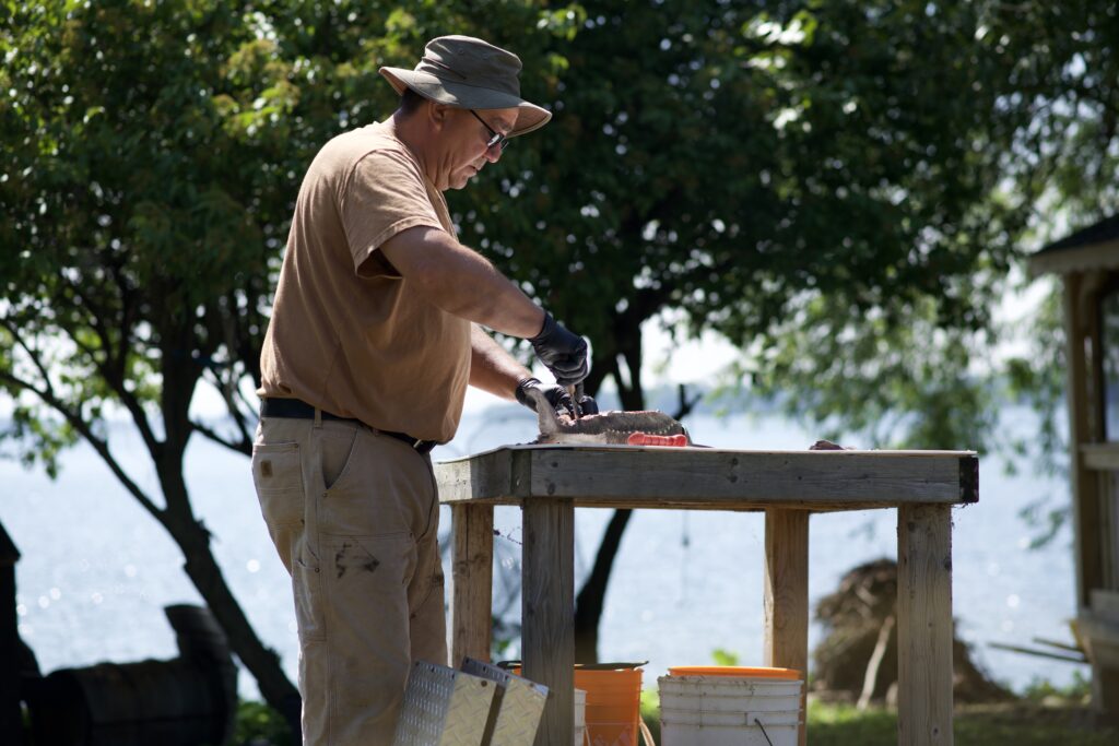 Older man demonstrating how to debone fish